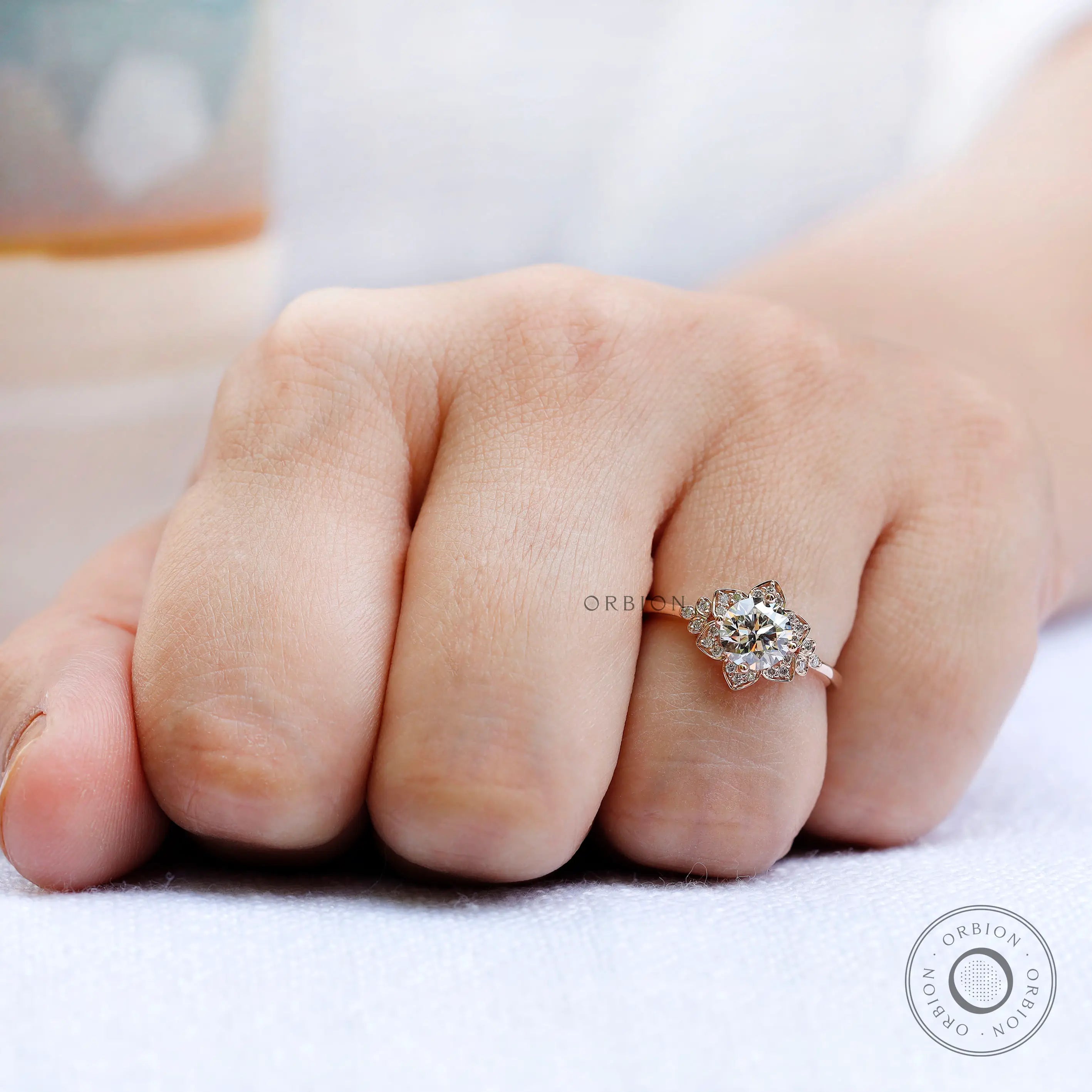 Rose gold halo ring highlighting tapered band design