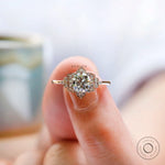 Detailed view of halo diamonds surrounding round center stone