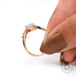 Curved accent pear diamond ring with round side diamonds