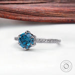 Blue lab grown diamond engagement ring with pavé band