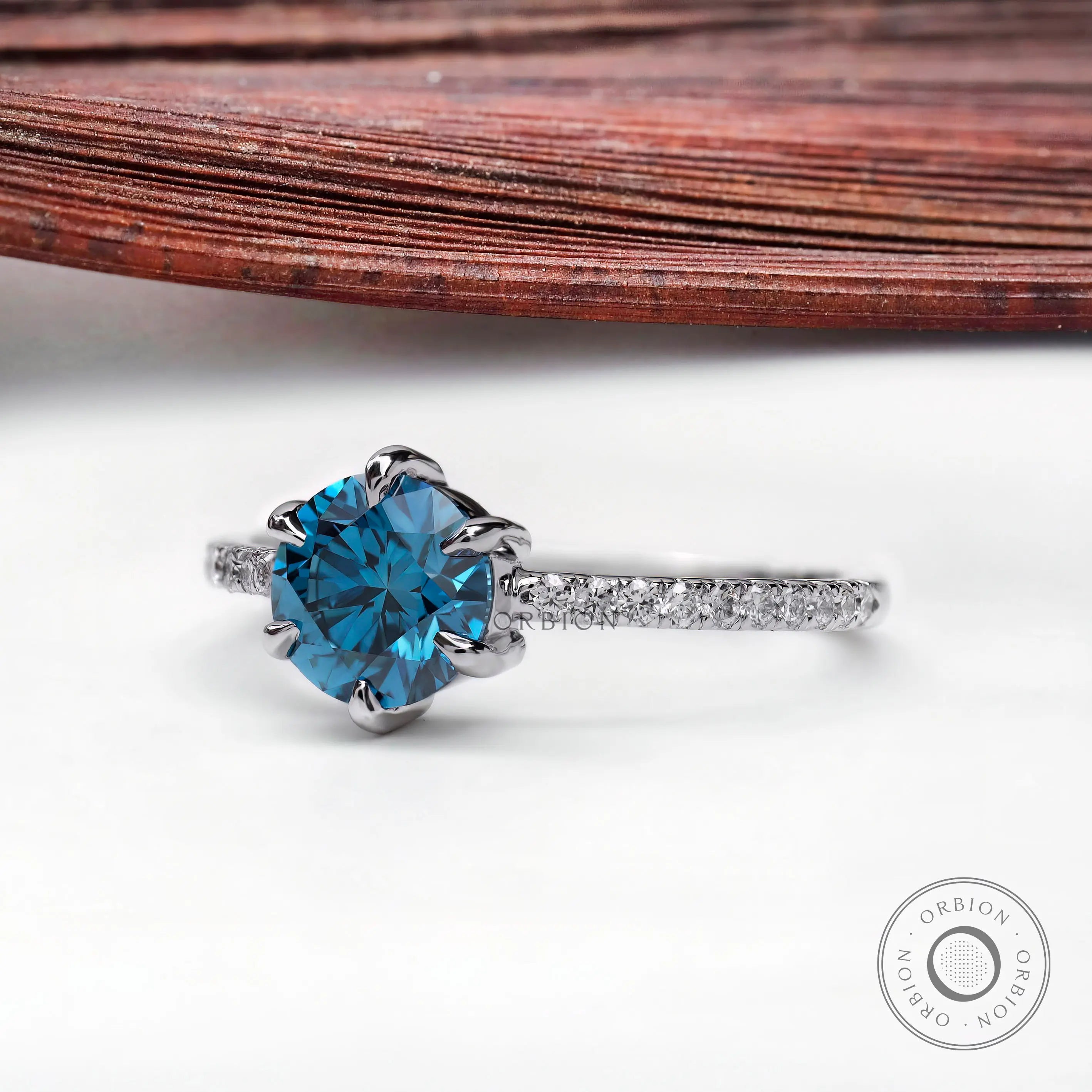 Blue lab grown diamond engagement ring with pavé band