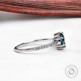 Round blue diamond ring showing pavé setting