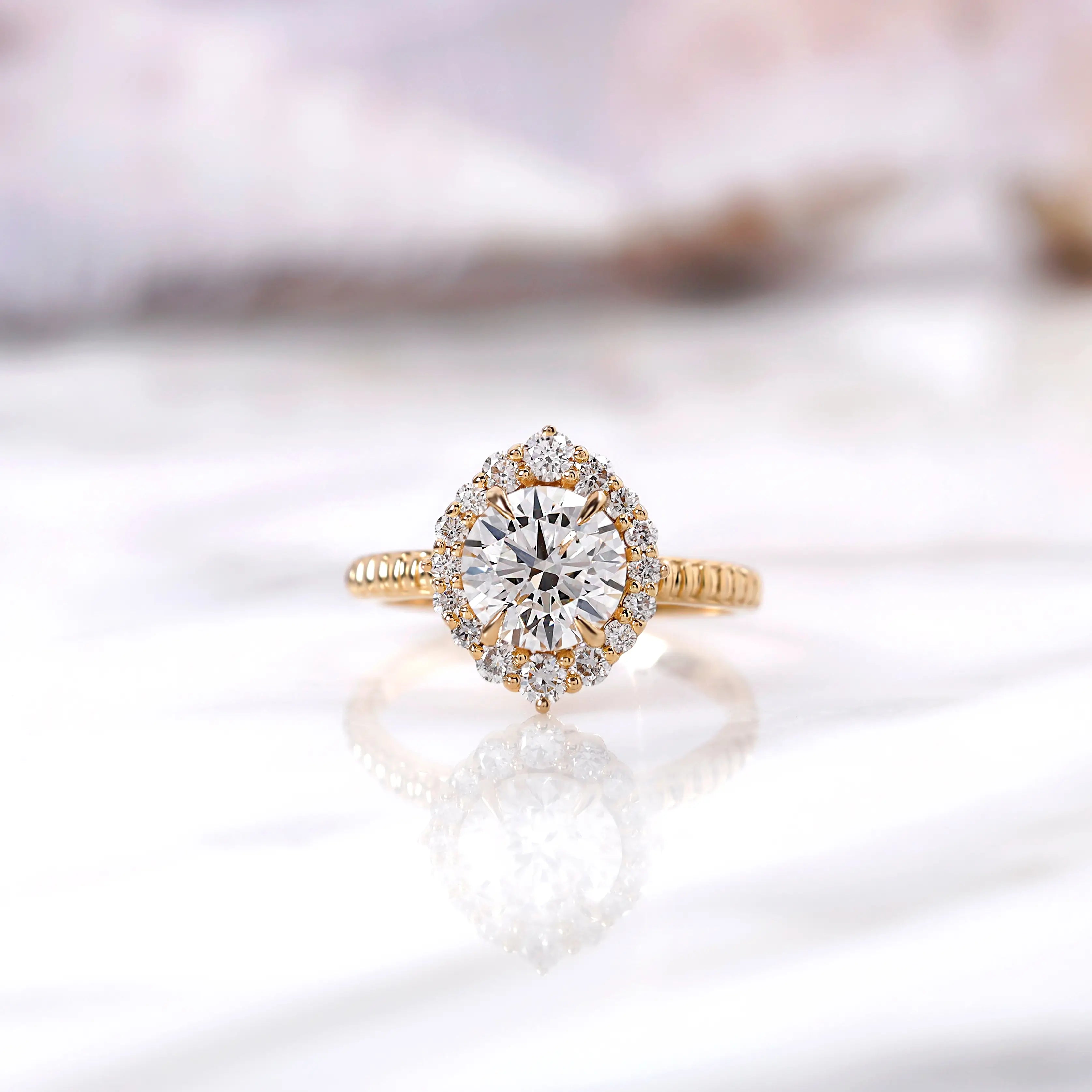 Round lab grown diamond halo engagement ring in 14K yellow gold front view