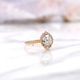 Angled view highlighting halo diamonds and polished yellow gold band