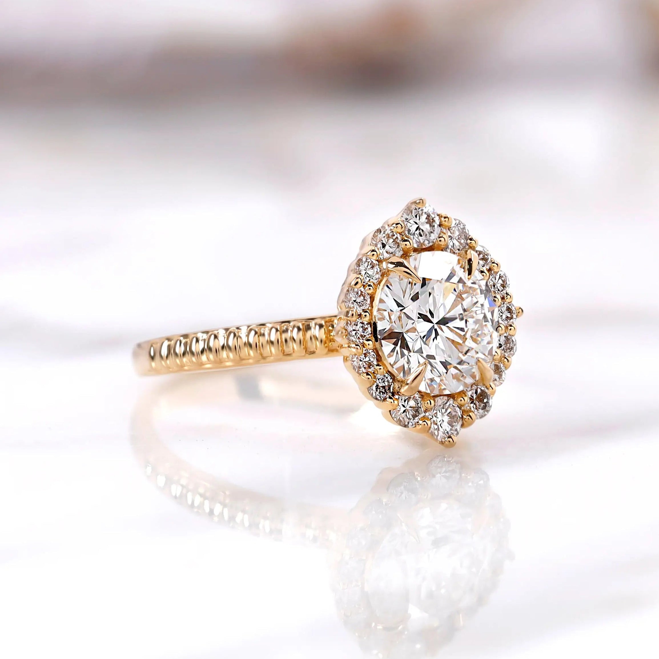 Angled view highlighting halo diamonds and polished yellow gold band