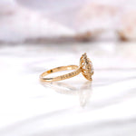 Side profile of round halo diamond ring with elevated basket setting