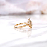 Side profile of round halo diamond ring with elevated basket setting