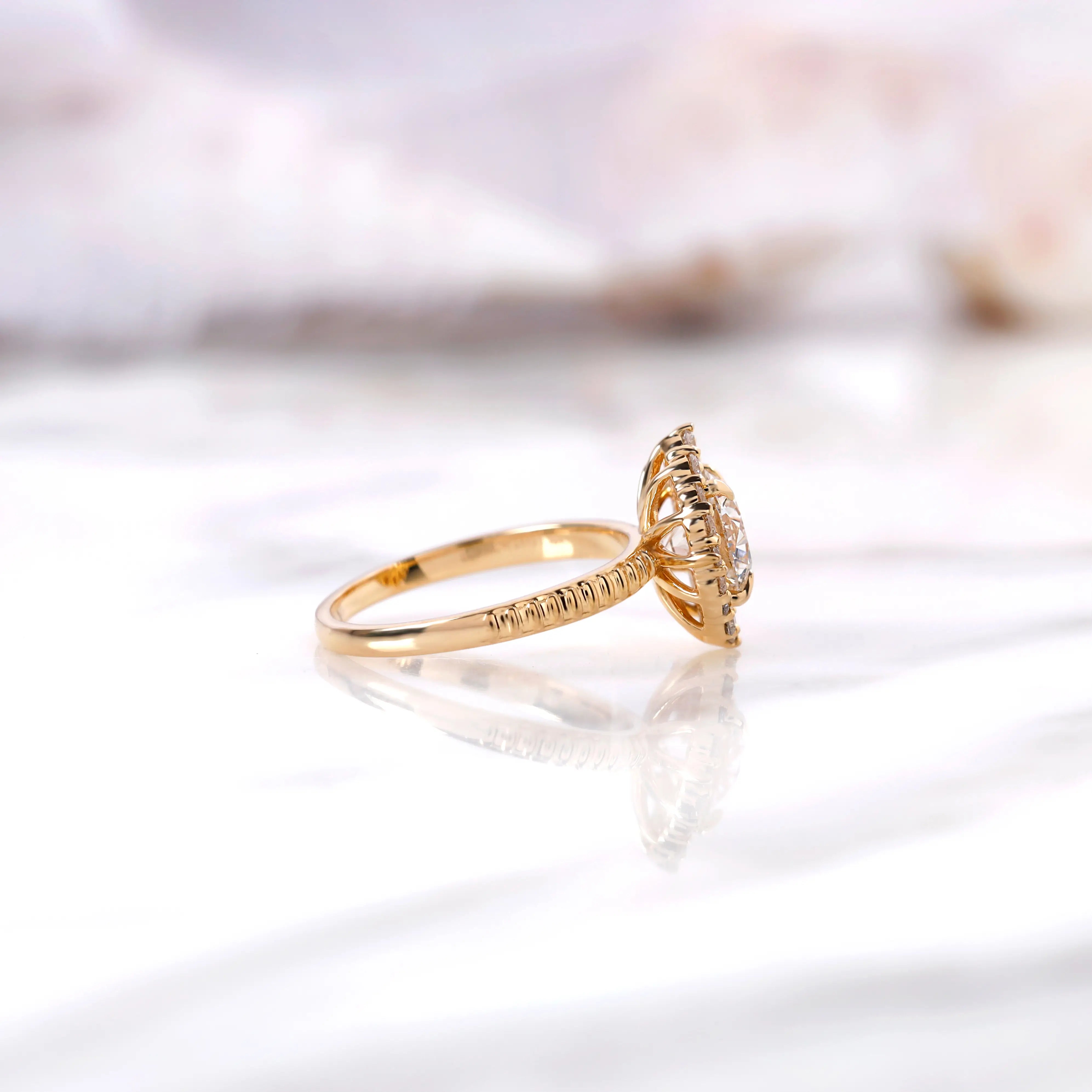 Side profile of round halo diamond ring with elevated basket setting