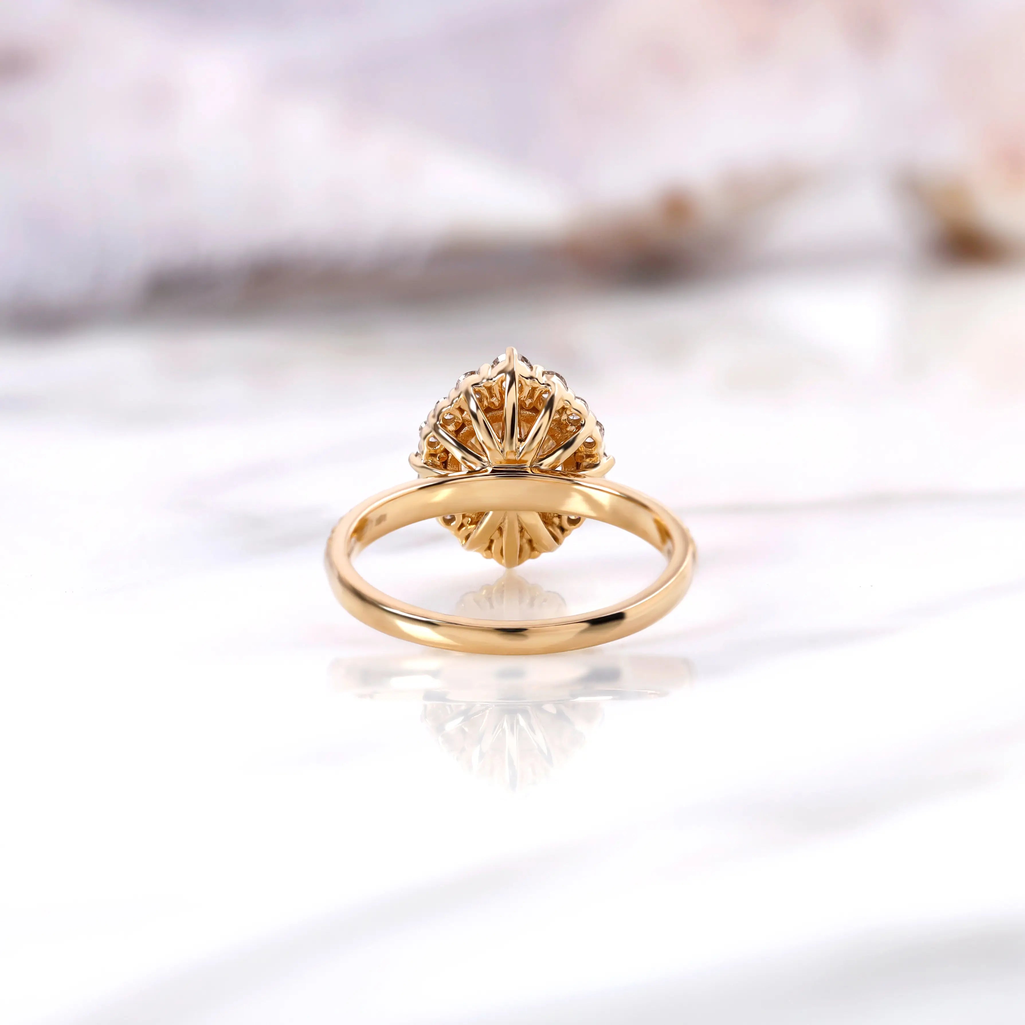 Back view of yellow gold halo engagement ring showing open gallery