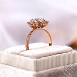 Round halo diamond ring displayed on jewelry box