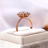 Round halo diamond ring displayed on jewelry box