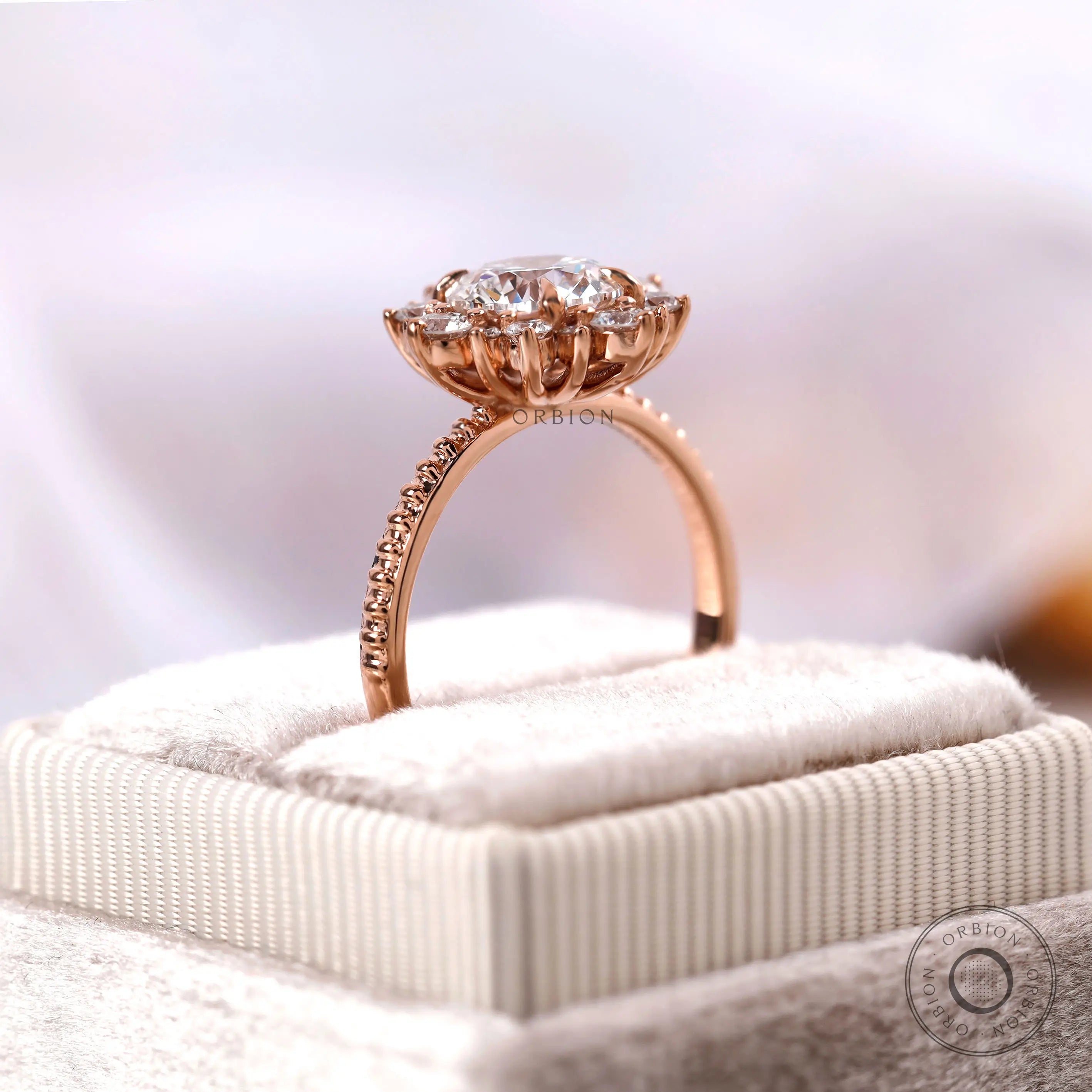 Round halo diamond ring displayed on jewelry box