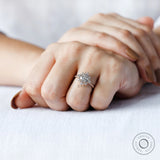 On-hand view of round lab grown diamond halo engagement ring