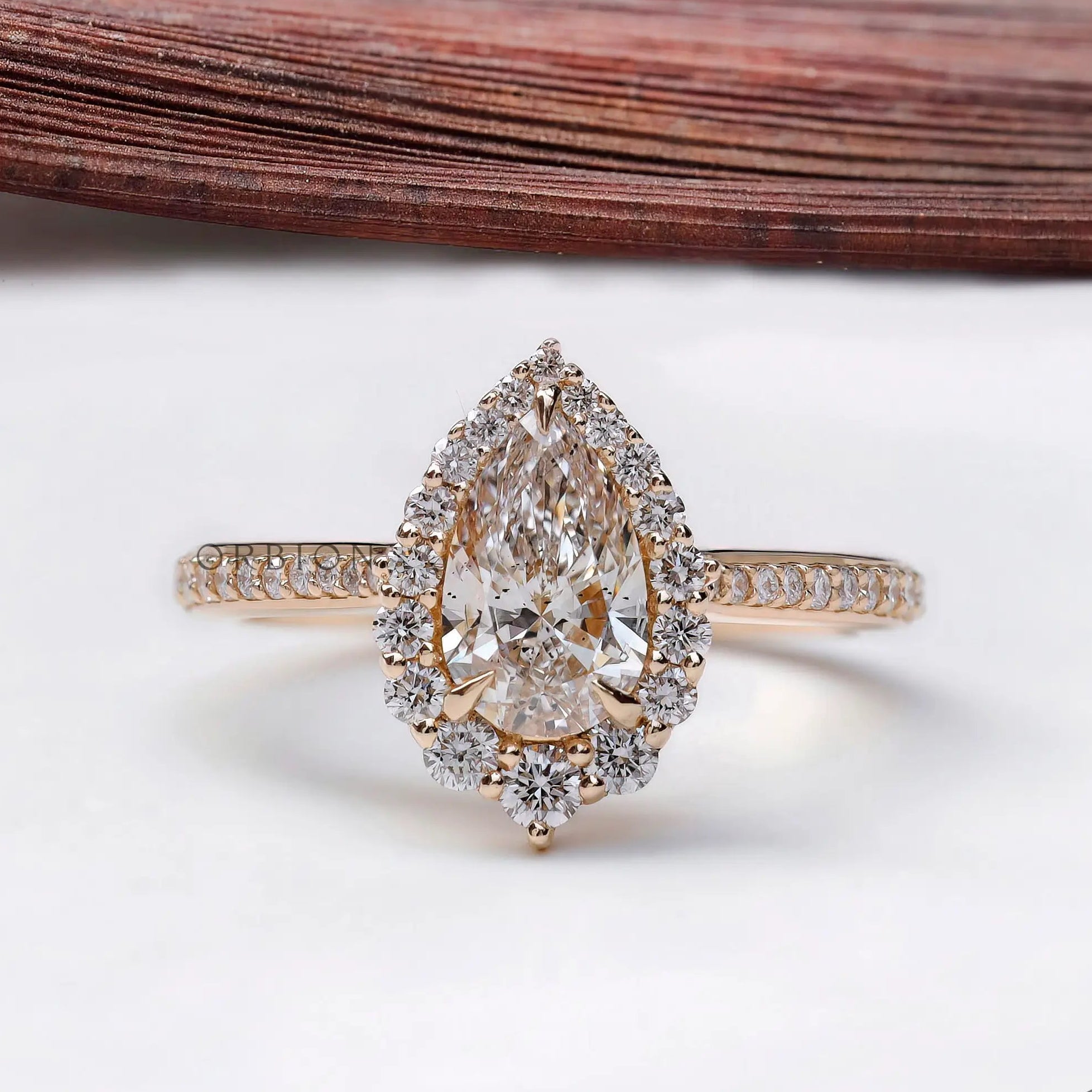 Pear cut lab grown diamond halo engagement ring in 14k yellow gold