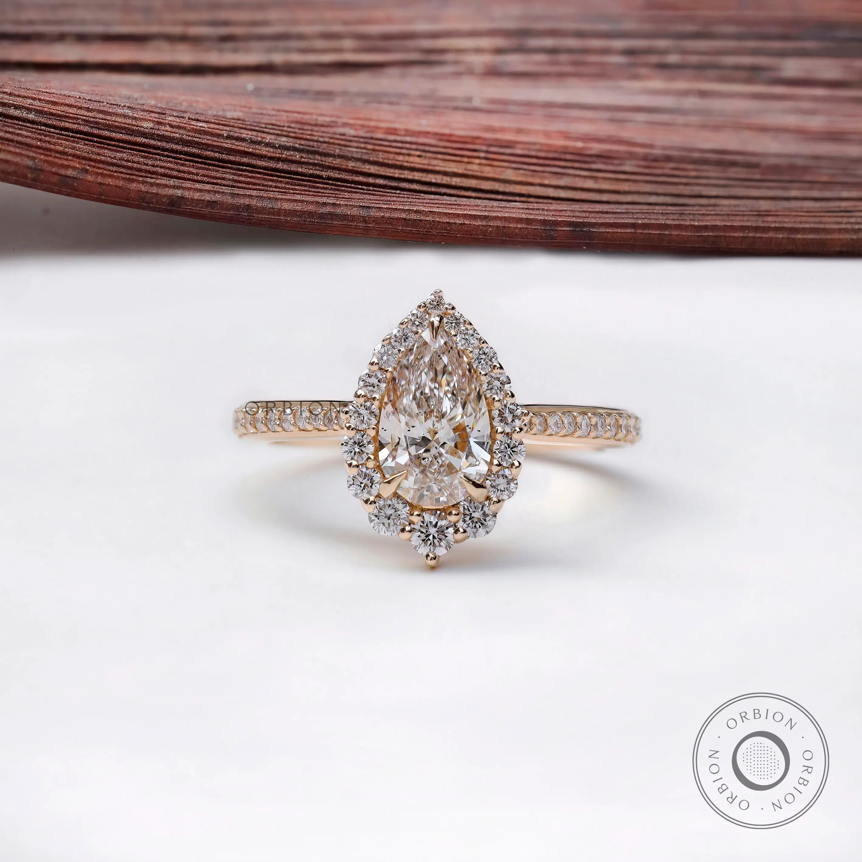 Pear cut lab grown diamond halo engagement ring in 14k yellow gold