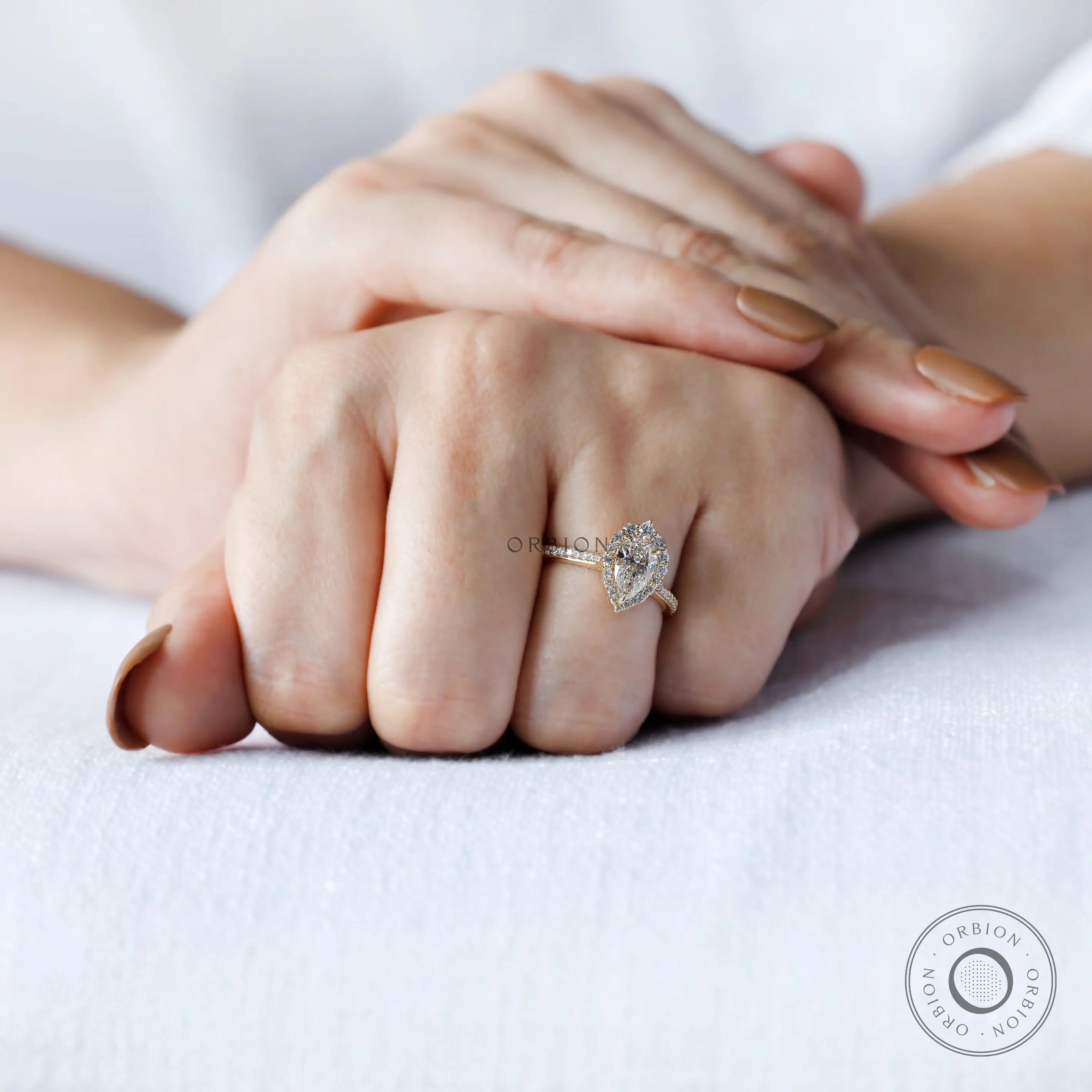 Yellow gold pear diamond ring with pavé accents