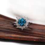 Round vivid blue diamond ring with marquise halo