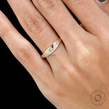 Side close view of yellow gold band with starburst set diamonds.
