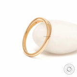 Back angled view of polished yellow gold band with slim profile.