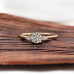 Round cut lab grown diamond three stone ring in yellow gold front view