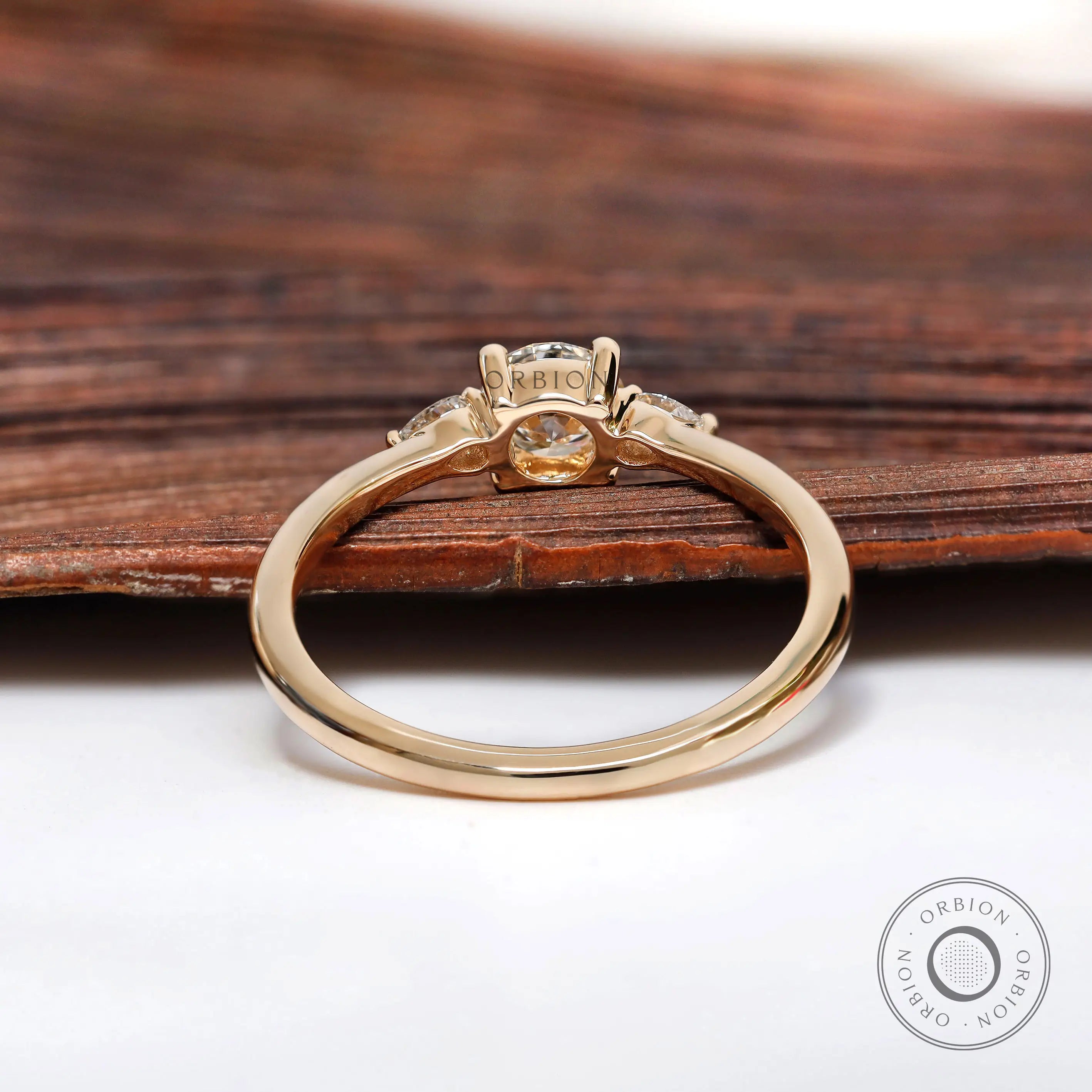 Rear view of prong set round and pear diamond ring