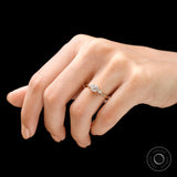 Close up of round brilliant center diamond with pear side stones