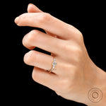 Three stone lab grown diamond ring worn on hand top view