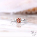 Cushion cut pink diamond ring with pear side stones