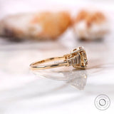 Side profile of baguette accented moissanite ring in yellow gold
