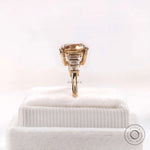 Step cut baguette side stone detail on champagne moissanite ring