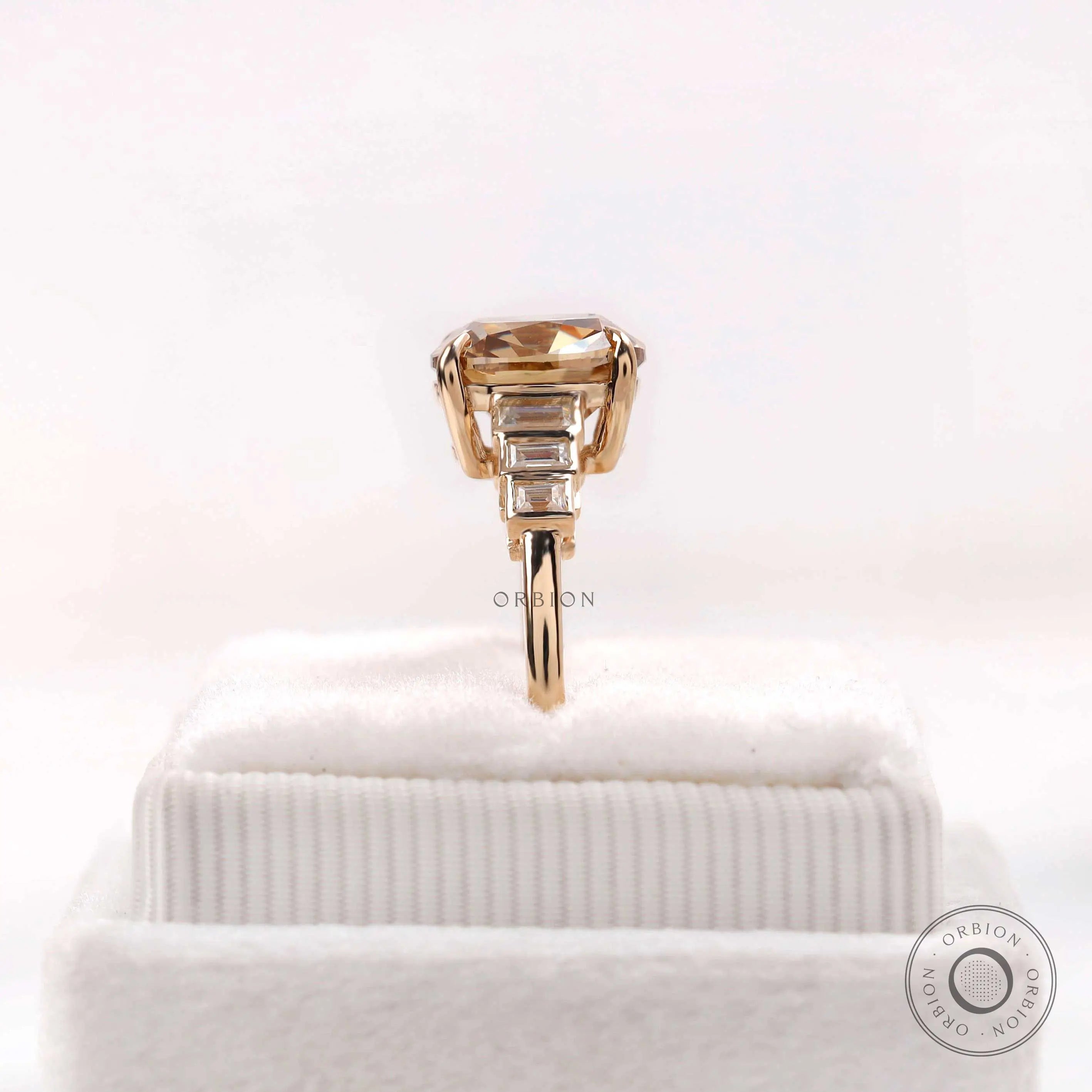 Step cut baguette side stone detail on champagne moissanite ring
