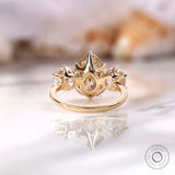 Crown style prong setting with pear center stone