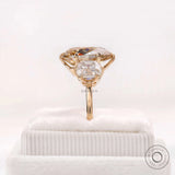 Pear moissanite ring with cushion accents