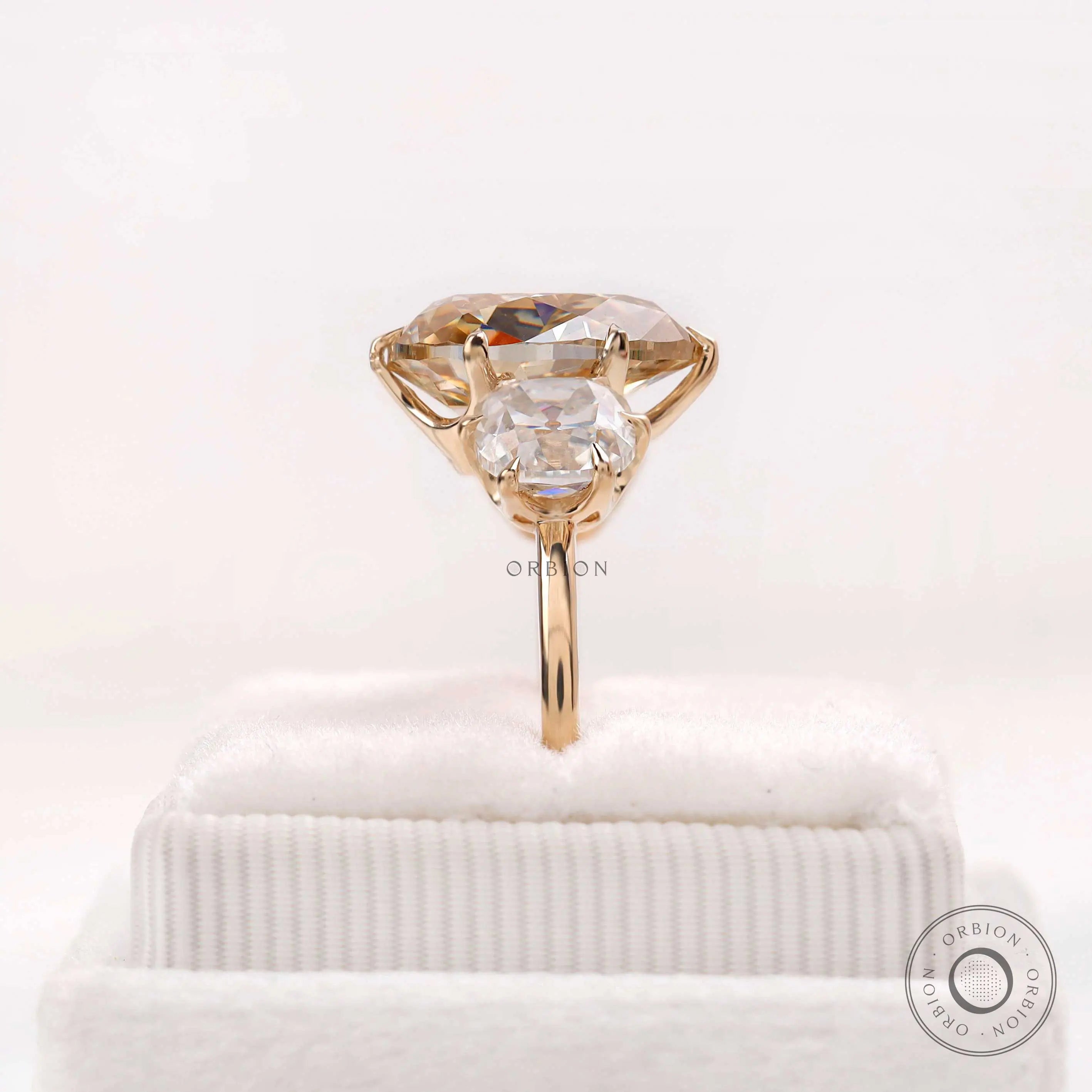 Pear moissanite ring with cushion accents