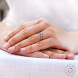 Ring worn on finger showing balanced three stone design