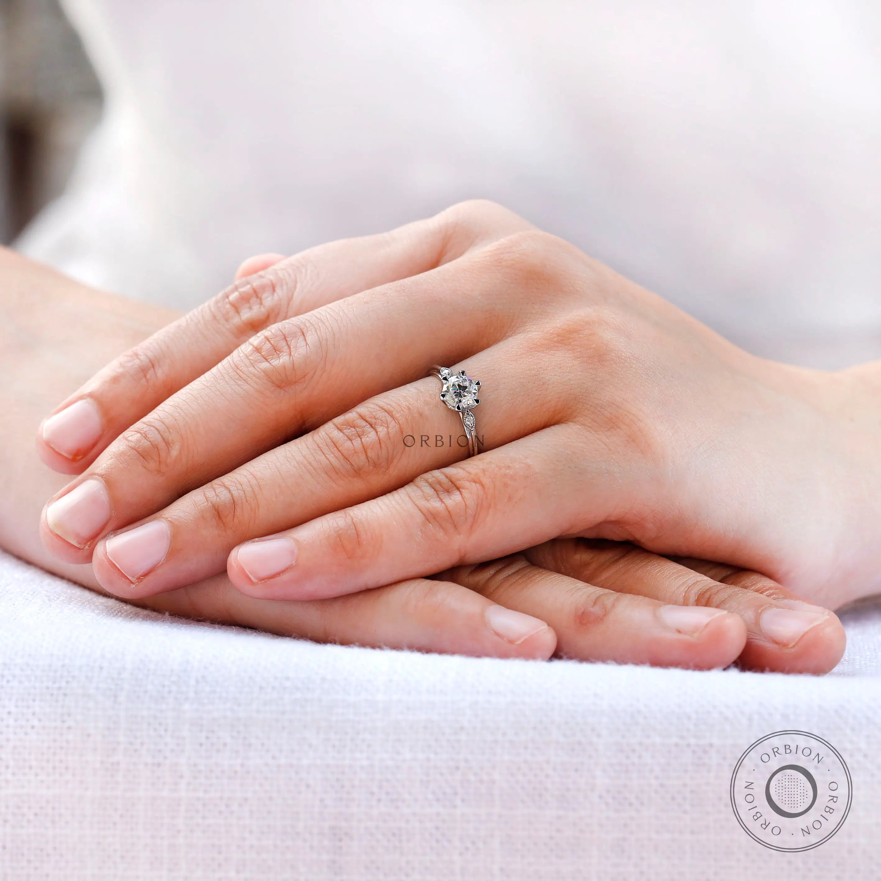 Ring worn on finger showing balanced three stone design