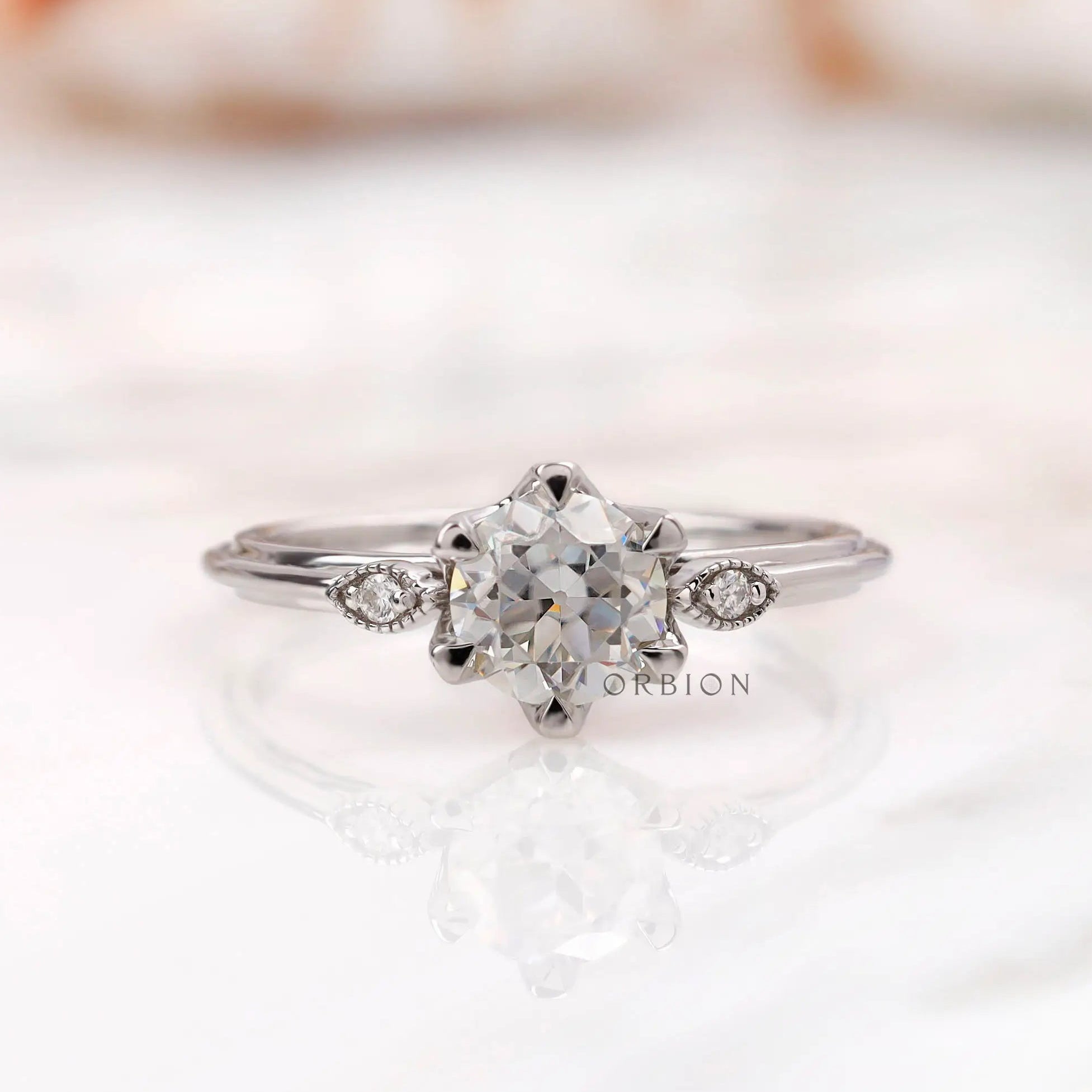 Three stone milgrain ring centered with Old European cut