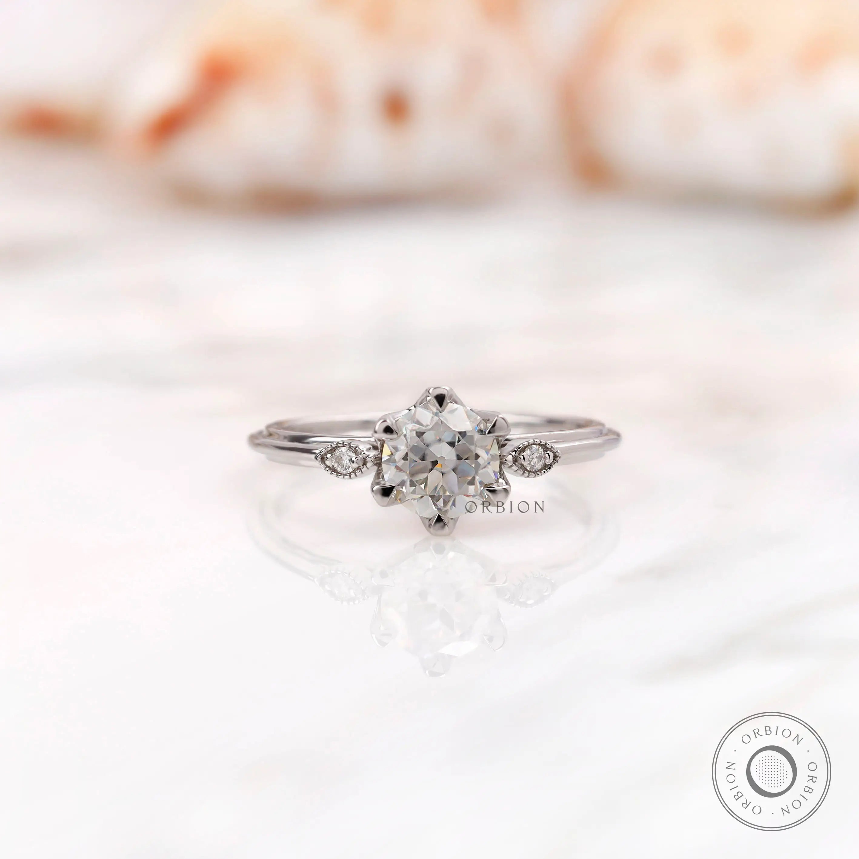 Three stone milgrain ring centered with Old European cut