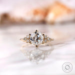 Front view of OEC Moissanite cluster engagement ring in yellow gold.
