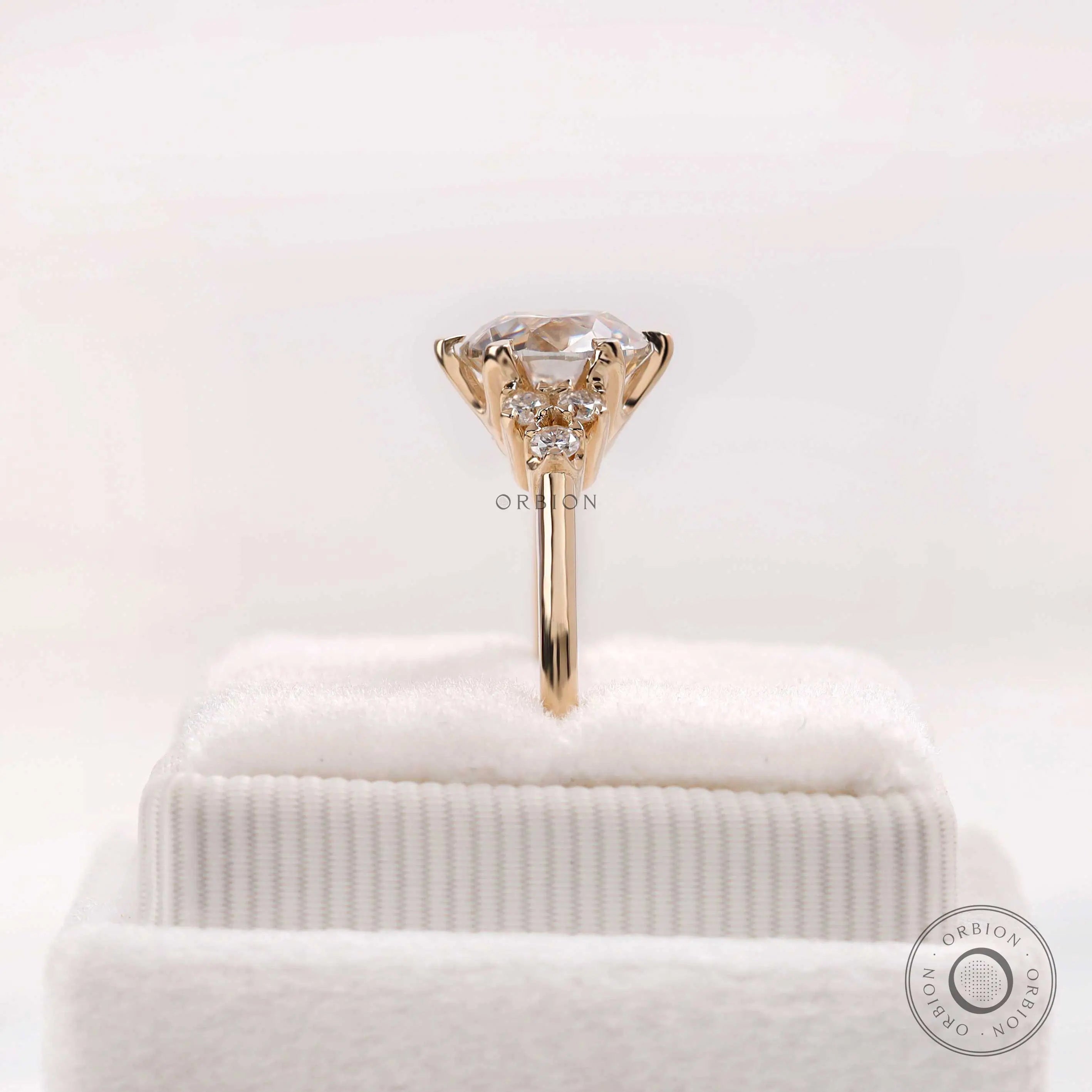 Side profile view cluster ring on soft white box