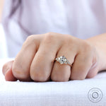 OEC Moissanite cluster engagement ring shown on finger with side view