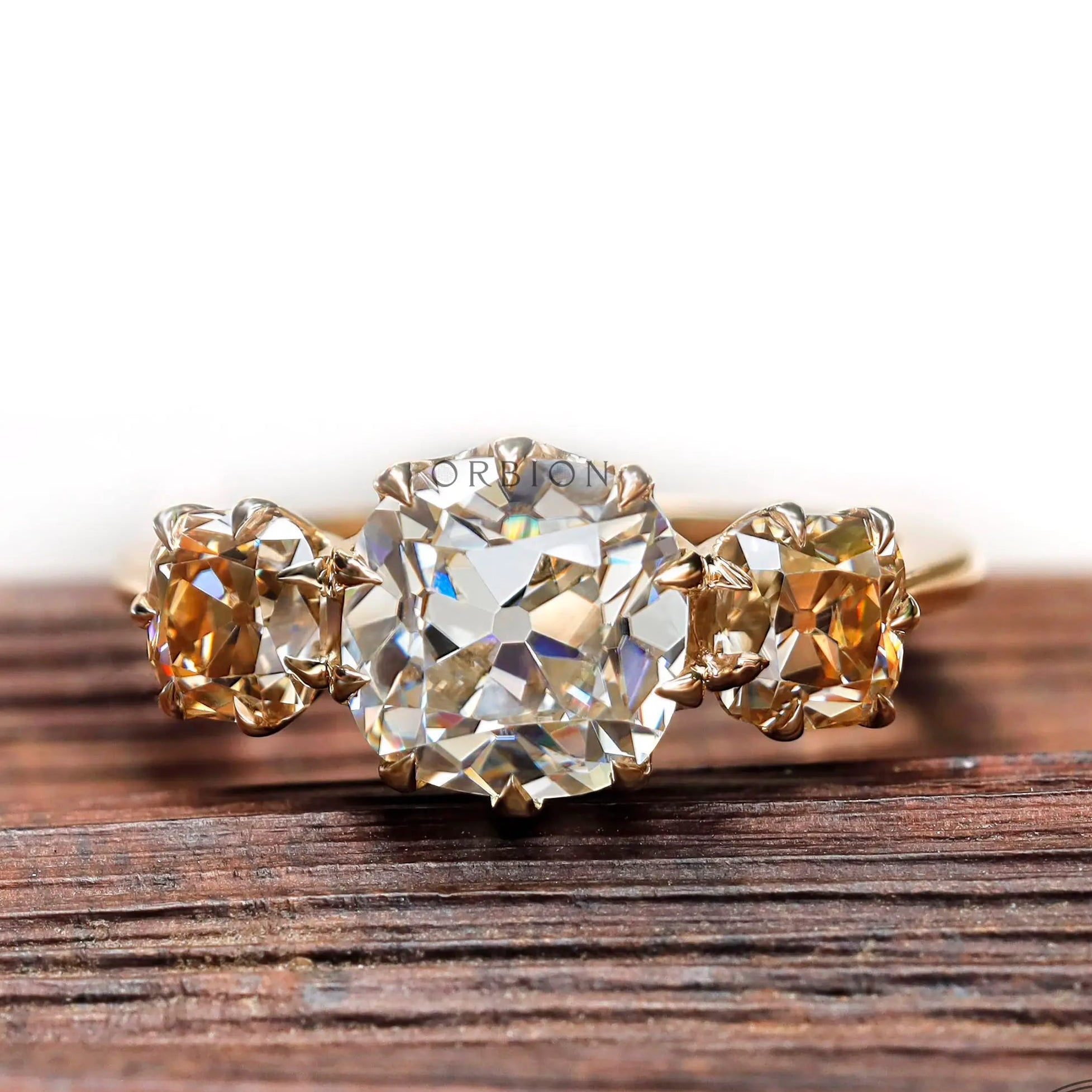 Three stone cushion Old Mine Cut moissanite ring in yellow gold front view