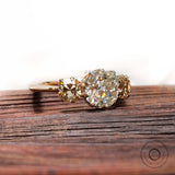 Vintage style moissanite engagement ring with champagne side stones close up