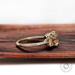 Side profile of three stone cushion moissanite ring in 10K yellow gold