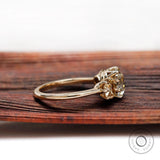 Side profile of three stone cushion moissanite ring in 10K yellow gold