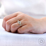 Antique inspired three stone moissanite ring finger shot