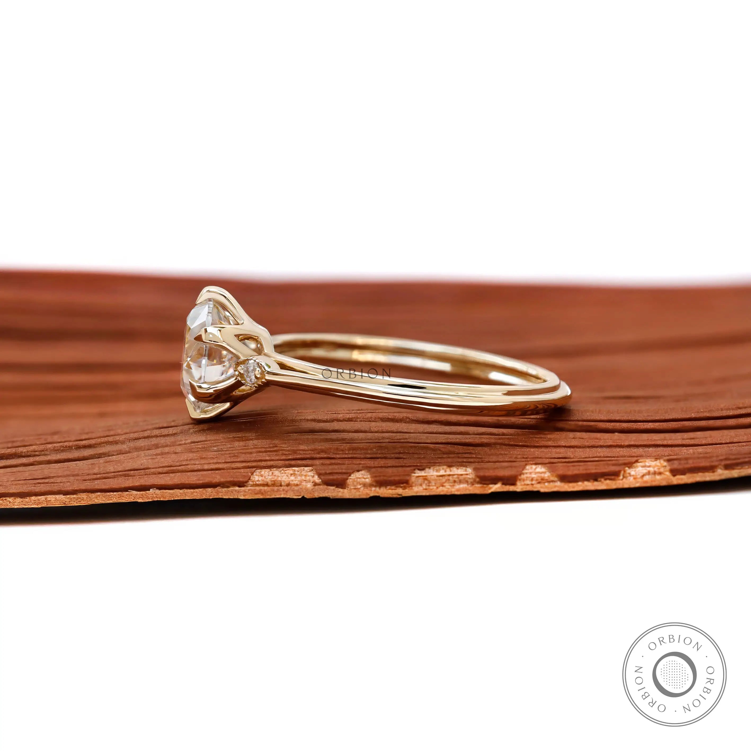 Yellow gold three stone engagement ring side profile view
