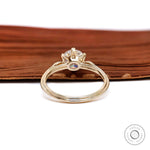 High polish yellow gold three stone moissanite ring rear view