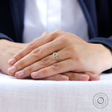 Minimal three stone moissanite ring worn on hand