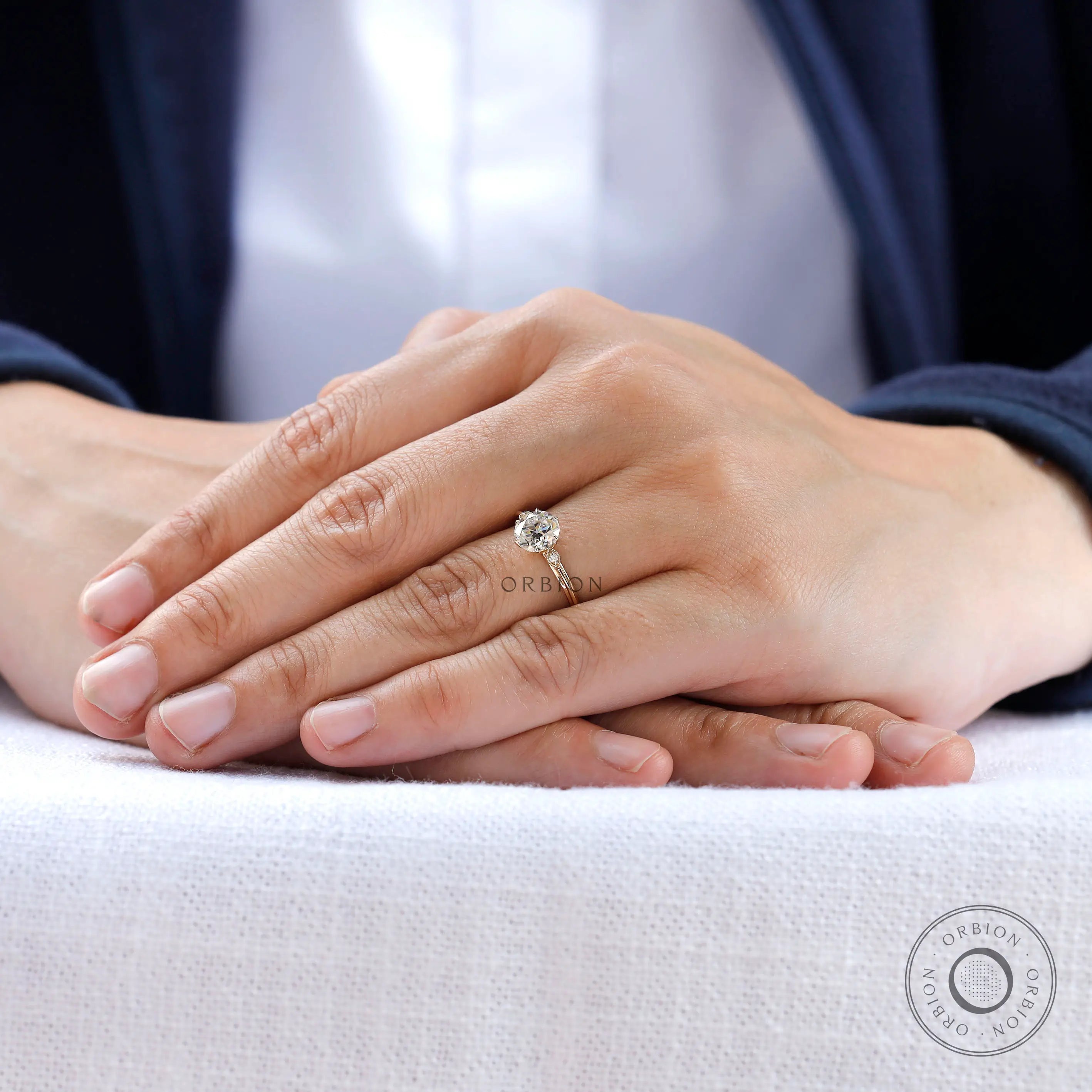 Minimal three stone moissanite ring worn on hand